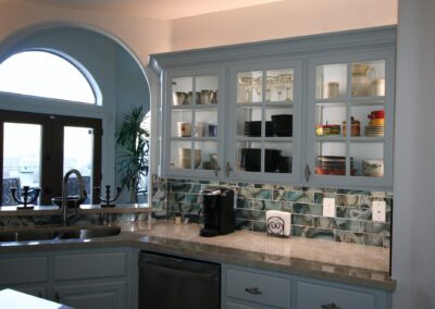 A kitchen with blue cabinets and counter tops.