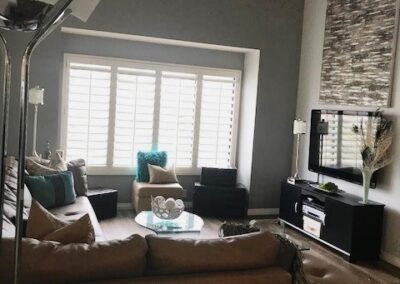 A living room with a couch, coffee table and tv.