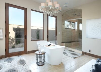 A large bathroom with a bathtub and glass doors.