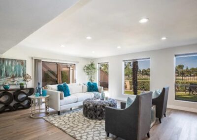 A living room with hardwood floors and a view of the golf course.