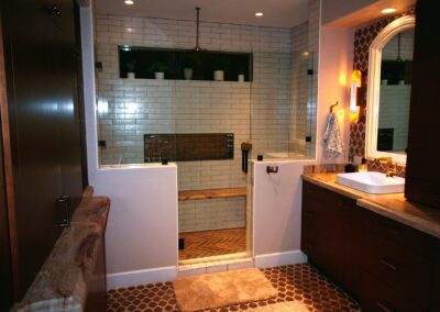 A bathroom with a walk in shower and a sink.