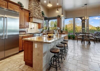 A kitchen with granite counter tops and stainless steel appliances.