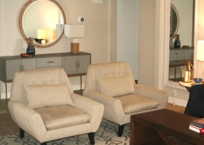 A living room with two chairs and a coffee table.