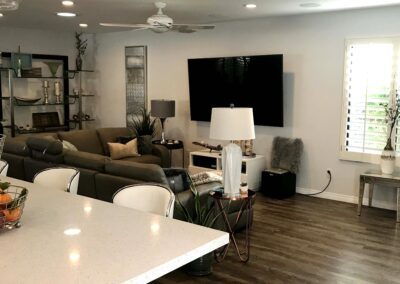 A living room with hardwood floors and a tv.