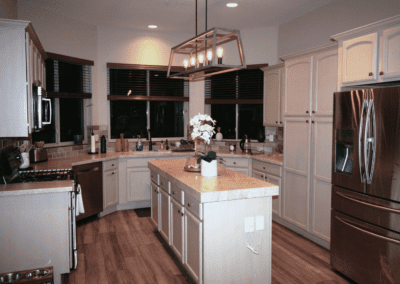 A kitchen with white cabinets and stainless steel appliances.