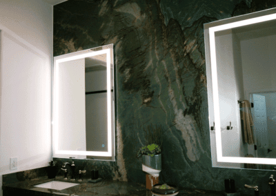 A bathroom with two sinks and a mirror.