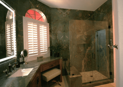 A bathroom with a shower stall and a sink.